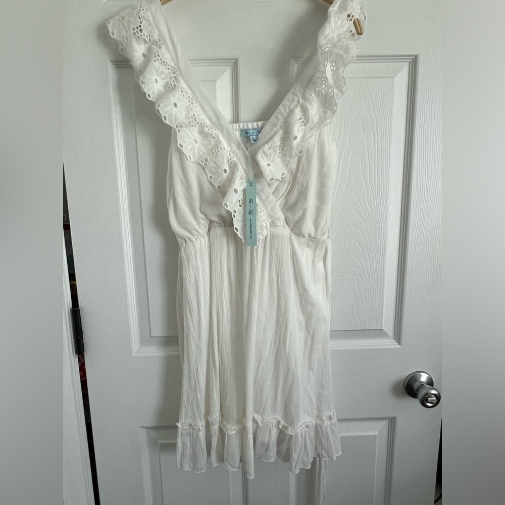 NWT size large she & sky white eyelet mini dress.  Plunge neck. Ruffle